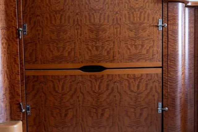 Slide: The Image of Wooden interior paneling of a 1997 Garlington Convertible, featuring intricate grain patterns. - 50