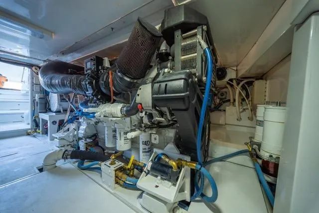 Slide: The Image of Engine room of a 1997 Garlington Convertible boat, showcasing complex machinery and components. - 52