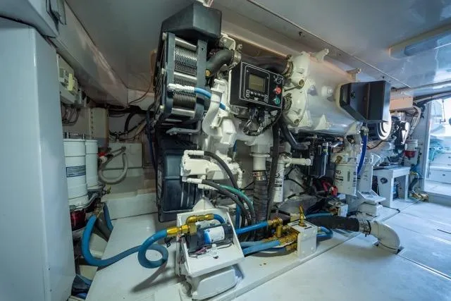 Slide: The Image of Engine room of a 1997 Garlington Convertible boat, showcasing complex machinery and equipment. - 53