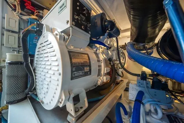 Slide: The Image of Engine room of a 1997 Garlington Convertible boat, showcasing machinery and components. - 56