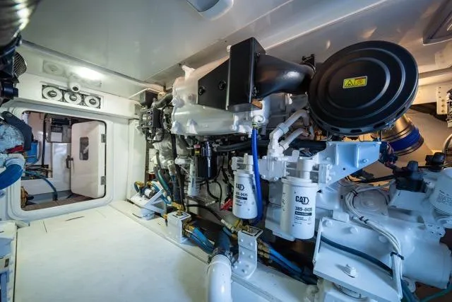 Slide: The Image of Engine room of a 1997 Garlington Convertible boat, featuring CAT machinery and components. - 58