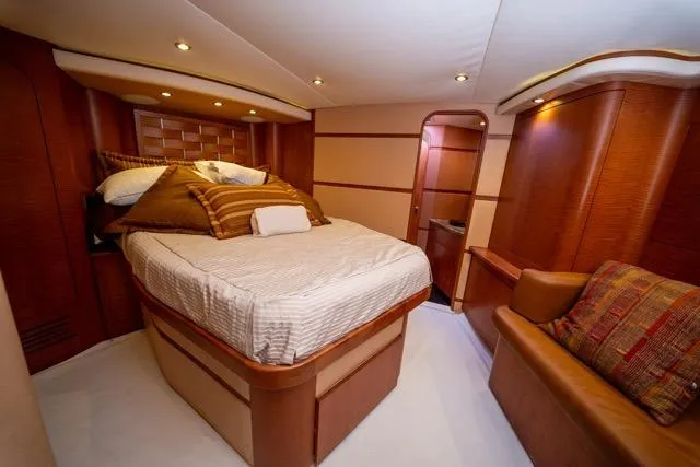Slide: The Image of Luxurious 1997 Garlington Convertible yacht interior with cozy bedroom and elegant wood finishes. - 6