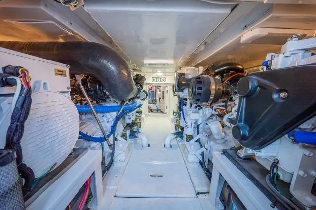 Slide: The Image of Engine room of a 1997 Garlington Convertible boat, showcasing mechanical components. - 60