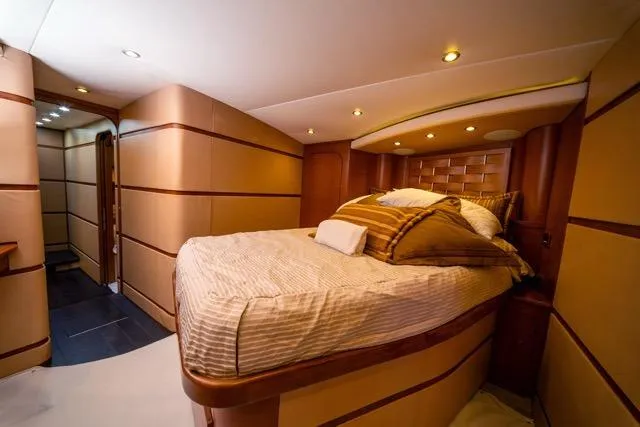 Slide: The Image of Luxurious bedroom interior of a 1997 Garlington Convertible yacht with elegant wood accents. - 7