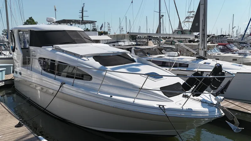 Slide: The Image of 2007 Sea Ray 40 Motor Yacht docked in marina, sleek design, white exterior. - 2