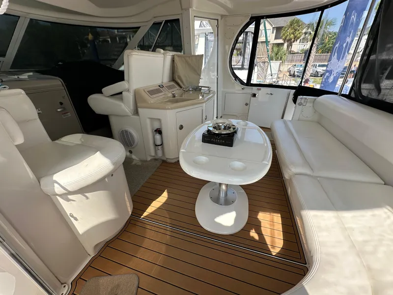 Slide: The Image of 2007 Sea Ray 40 Motor Yacht helm with wood steering wheel and modern navigation controls. - 21