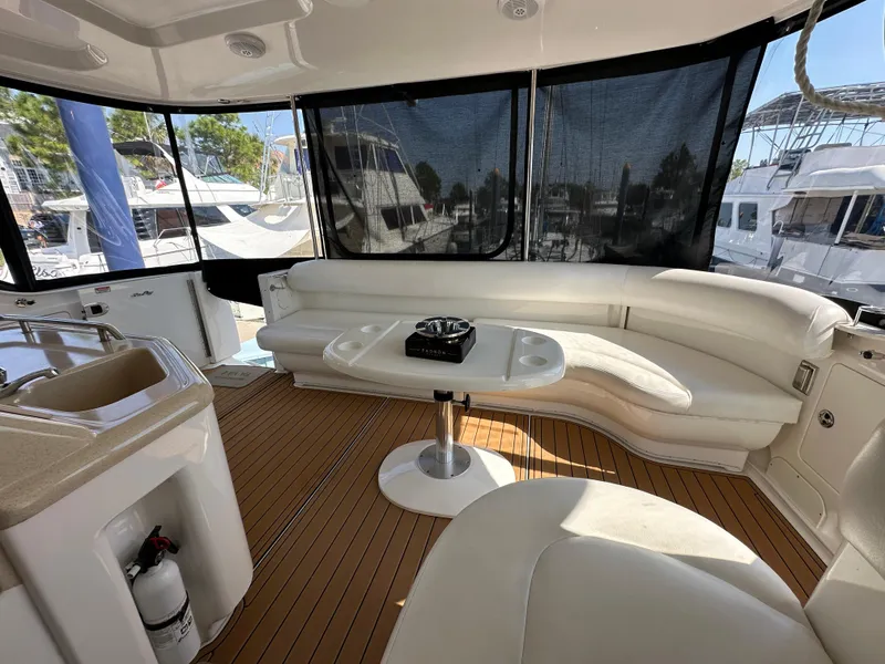 Slide: The Image of 2007 Sea Ray 40 Motor Yacht helm with wood steering wheel and modern controls. - 22