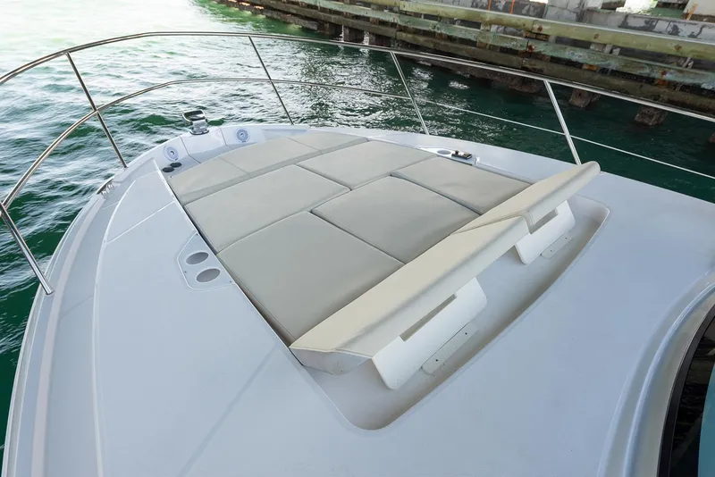 Slide: The Image of Manufacturer Provided Image: 2025 Regal 38 FXO boat with spacious sunbathing deck by the water. - 103