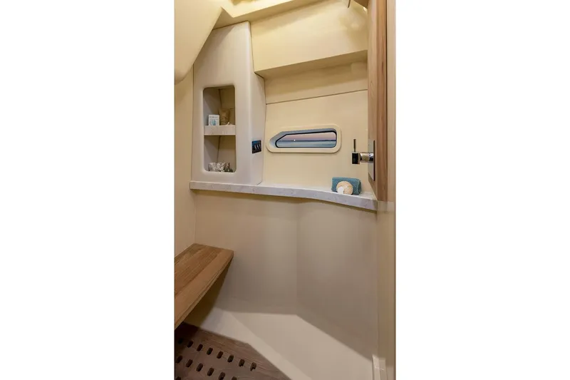 Slide: The Image of Manufacturer Provided Image: Interior of 2025 Regal 38 FXO boat, featuring a compact, modern bathroom with shelving. - 115