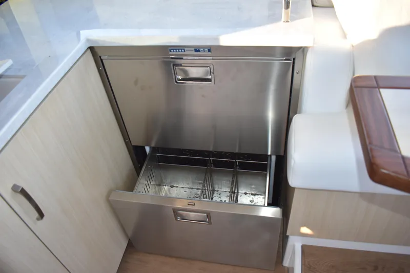 Slide: The Image of 2025 Regal 38 FXO yacht interior with stainless steel drawer refrigerator. - 25