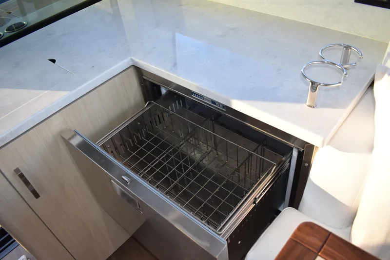 Slide: The Image of Open dishwasher in the 2025 Regal 38 FXO yacht kitchen area. - 26
