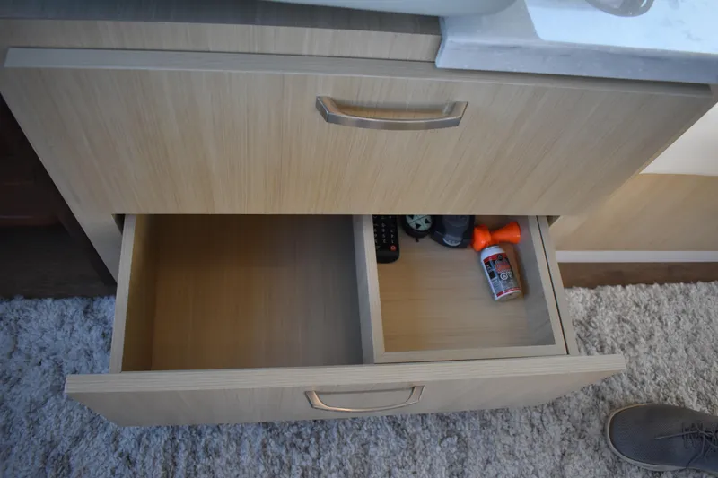 Slide: The Image of Open drawer in Regal 38 FXO yacht, showing remote and air horn. - 32