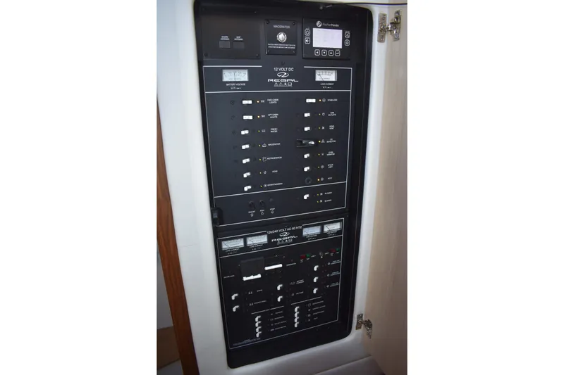 Slide: The Image of Electrical control panel of 2025 Regal 38 FXO boat, featuring various switches and indicators. - 38