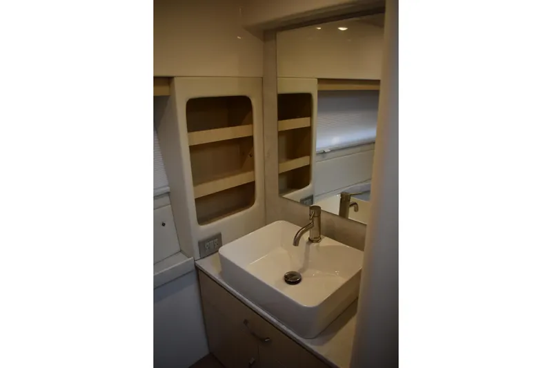 Slide: The Image of Modern bathroom sink in 2025 Regal 38 FXO yacht, featuring sleek design and storage shelves. - 40