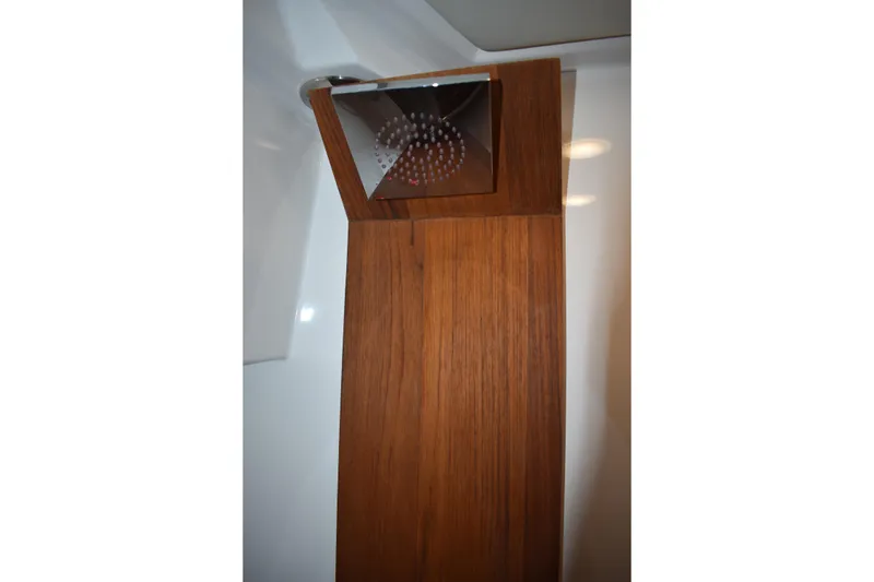 Slide: The Image of Shower area in 2025 Regal 38 FXO boat with wooden paneling. - 42