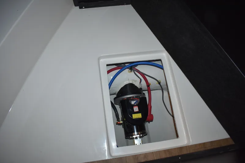 Slide: The Image of 2025 Regal 38 FXO boat interior compartment with visible wiring and components. - 43