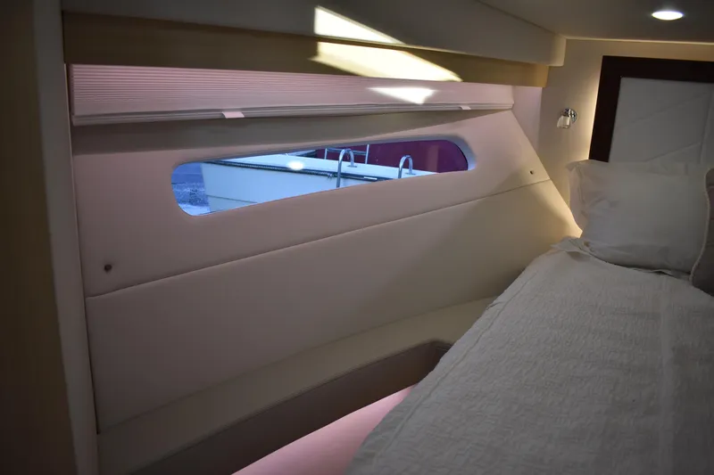 Slide: The Image of Interior cabin view of 2025 Regal 38 FXO yacht with bed and window. - 45