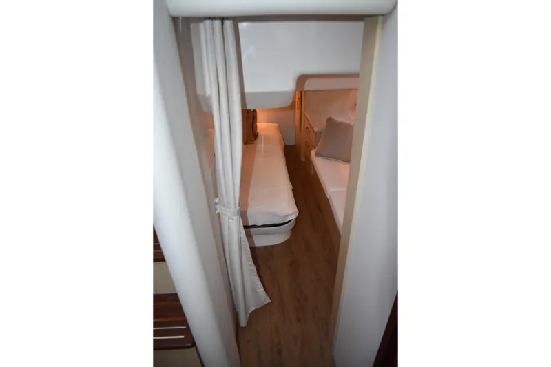 Slide: The Image of Interior cabin of 2025 Regal 38 FXO yacht with cozy beds and warm lighting. - 48