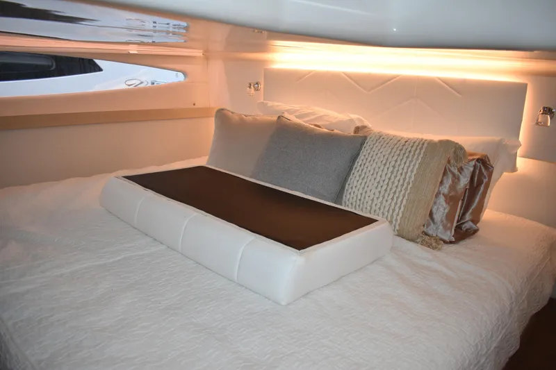 Slide: The Image of Luxurious cabin interior of 2025 Regal 38 FXO yacht with elegant bedding and ambient lighting. - 49