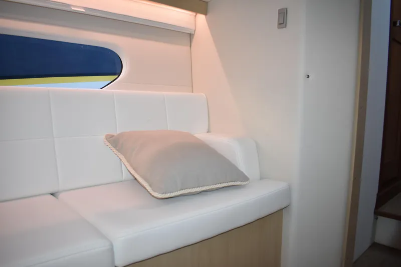 Slide: The Image of Interior of 2025 Regal 38 FXO yacht with white seating and cushion. - 53