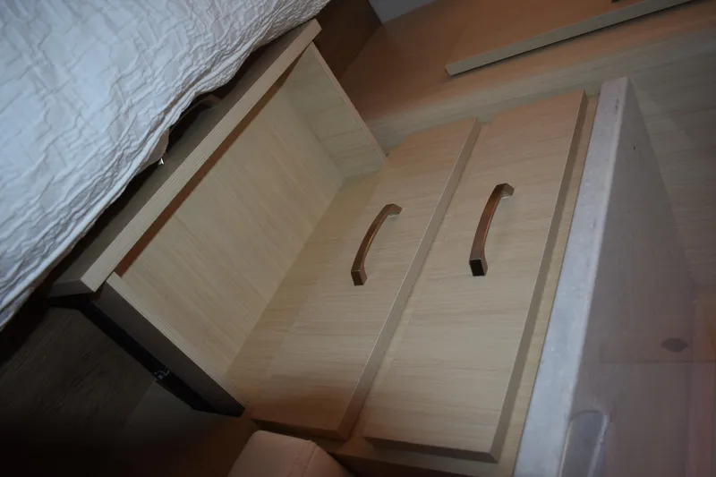 Slide: The Image of Wooden cabinet with open drawer, featuring sleek handles, inside a 2025 Regal 38 FXO. - 56