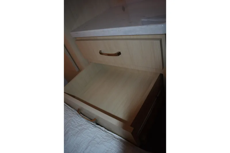 Slide: The Image of Open drawer in 2025 Regal 38 FXO boat interior, showcasing wooden cabinetry. - 57