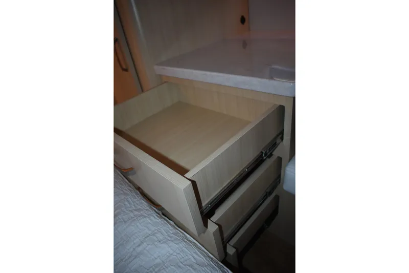 Slide: The Image of Open wooden drawer in 2025 Regal 38 FXO boat interior. - 58