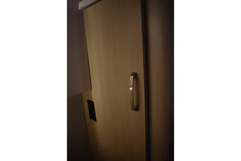 Slide: The Image of Wooden cabinet door with sleek handle on 2025 Regal 38 FXO boat. - 59
