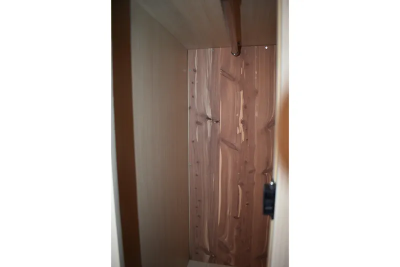 Slide: The Image of 2025 Regal 38 FXO wooden interior closet with hanging rod. - 60