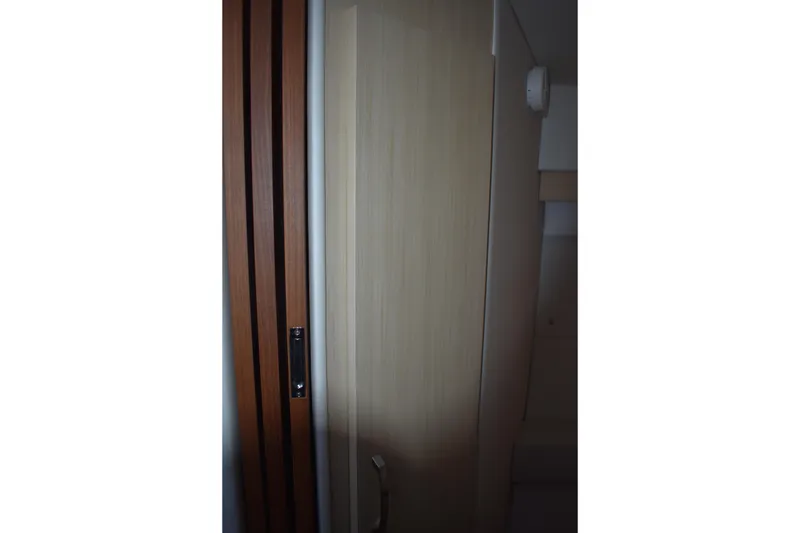 Slide: The Image of Interior view of 2025 Regal 38 FXO yacht, featuring sleek wooden door design. - 63