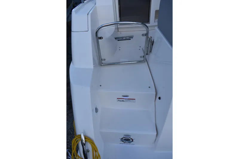 Slide: The Image of 2025 Regal 38 FXO boat deck with steps and safety gate. - 74