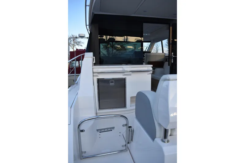 Slide: The Image of 2025 Regal 38 FXO yacht interior with sleek seating and modern amenities. - 75