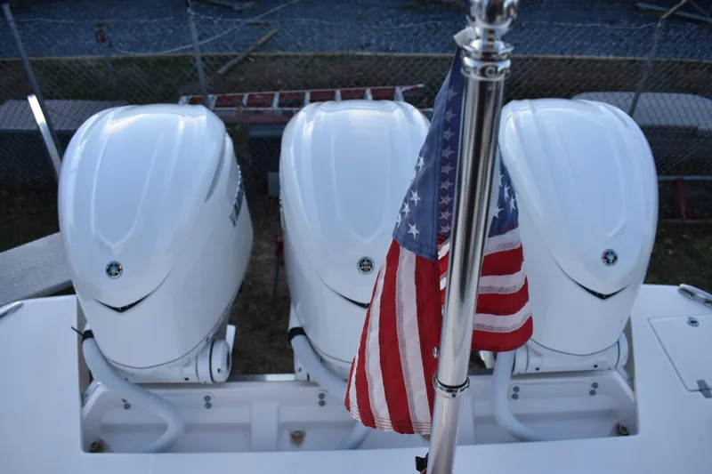 Slide: The Image of Triple outboard engines on 2025 Regal 38 FXO boat with American flag. - 76