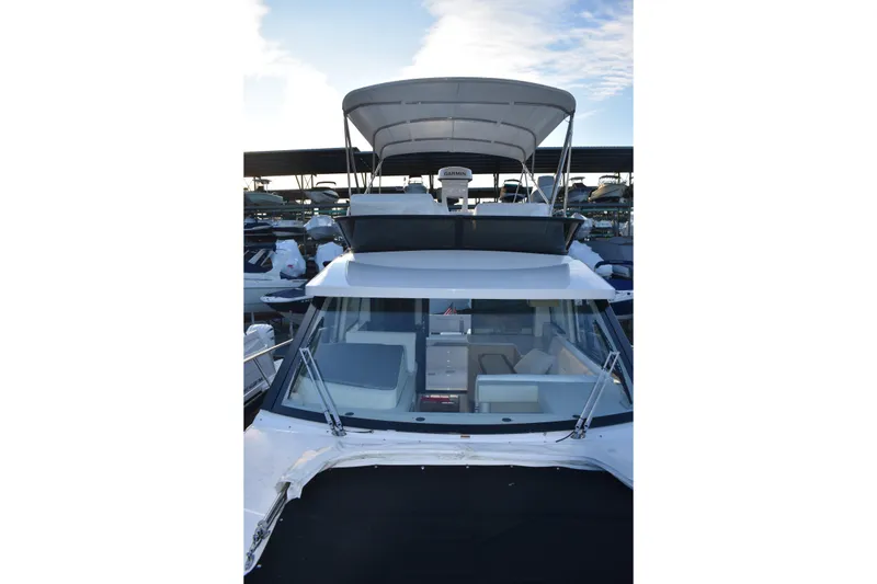 Slide: The Image of 2025 Regal 38 FXO yacht with flybridge, docked in marina. - 80