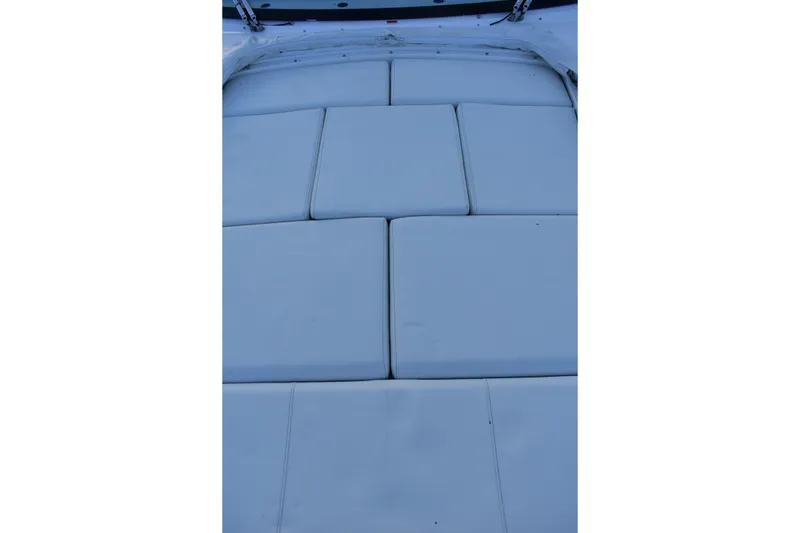 Slide: The Image of 2025 Regal 38 FXO boat with cushioned seating area, top view. - 81