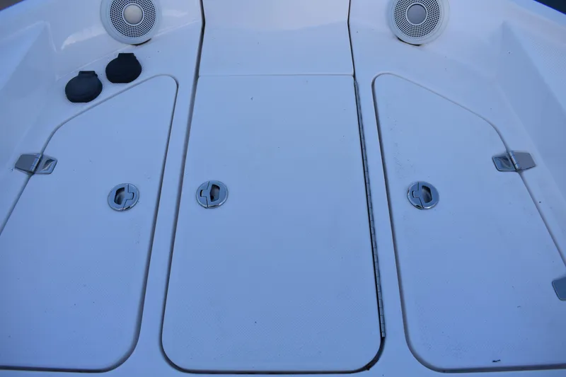 Slide: The Image of 2025 Regal 38 FXO boat deck with storage hatches and speakers. - 84