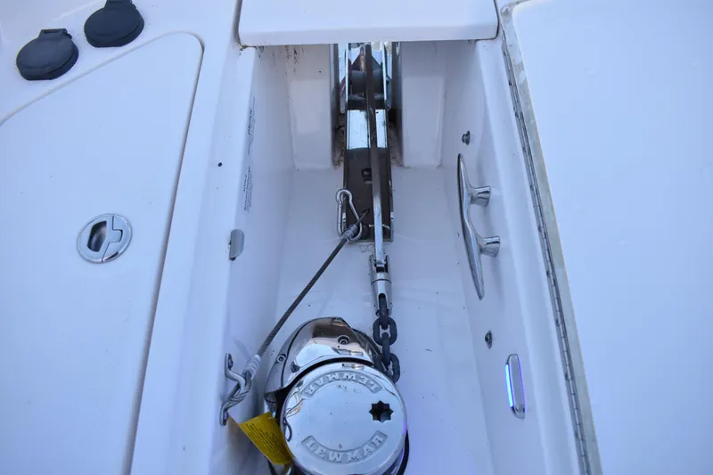 Slide: The Image of Anchor compartment of 2025 Regal 38 FXO boat, featuring winch and cleat. - 88