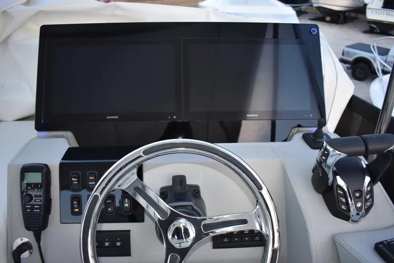 Slide: The Image of Helm of 2025 Regal 38 FXO boat with dual Garmin displays and controls. - 90