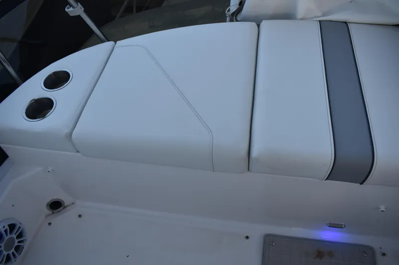 Slide: The Image of 2025 Regal 38 FXO boat seating area with cup holders and speaker. - 93