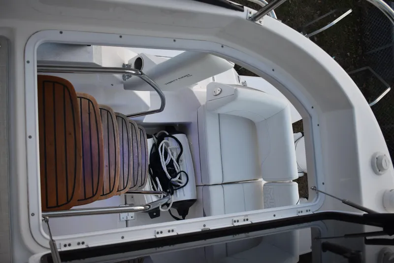 Slide: The Image of 2025 Regal 38 FXO boat interior with wooden steps and white seating. - 95