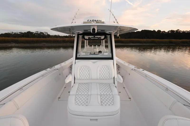 Slide: The Image of 2022 Sportsman Open 322 Center Console boat on calm water at sunset. - 15