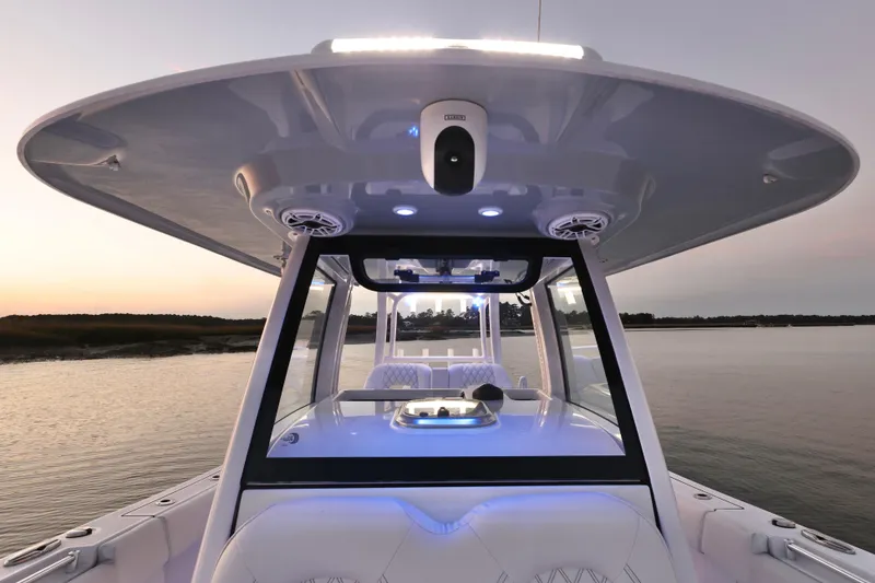 Slide: The Image of 2022 Sportsman Open 322 Center Console boat at sunset on calm water. - 18