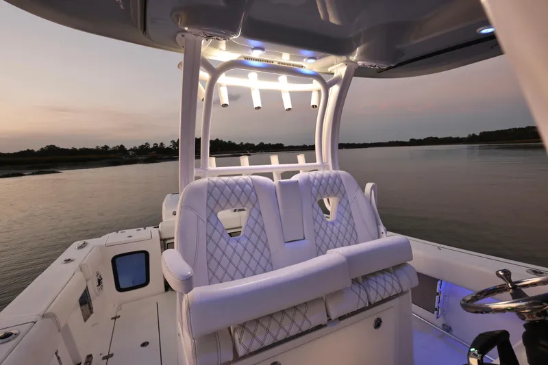 Slide: The Image of 2022 Sportsman Open 322 Center Console boat interior at sunset on calm water. - 19