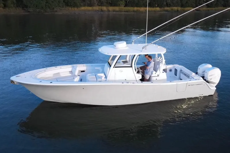 Slide: The Image of 2022 Sportsman Open 322 Center Console boat on calm water, side view. - 3