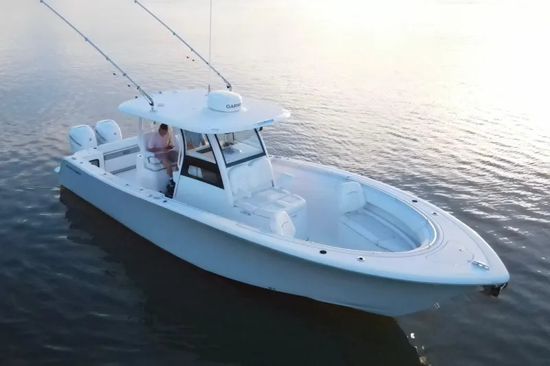 Slide: The Image of 2022 Sportsman Open 322 Center Console boat on calm water, featuring dual engines. - 5