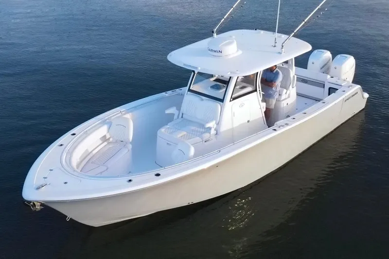 Slide: The Image of 2022 Sportsman Open 322 Center Console boat on calm water, featuring dual engines. - 6