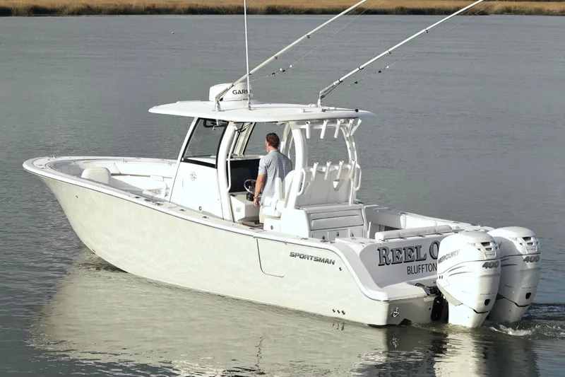 Slide: The Image of 2022 Sportsman Open 322 Center Console boat on calm water, rear view. - 9