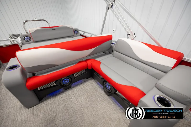 Slide: The Image of 2026 Avalon LSZ Vrl boat interior with red and gray seating, cup holders, and speakers. - 20