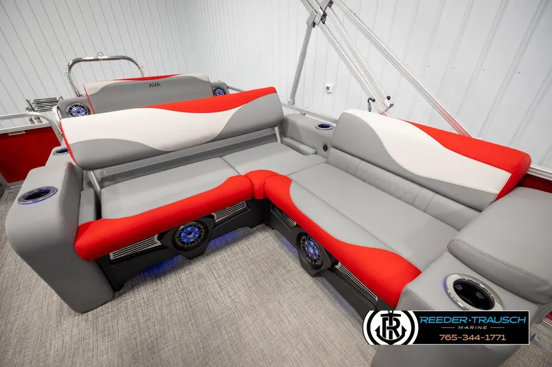 Slide: The Image of 2026 Avalon LSZ Vrl boat interior with red and gray seating, cup holders, and speakers. - 21