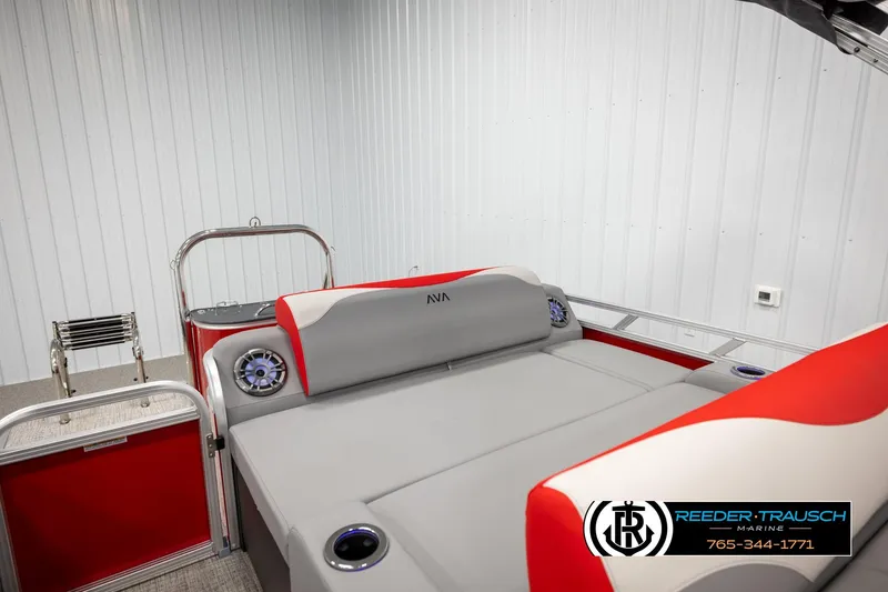 Slide: The Image of 2026 Avalon LSZ Vrl boat interior with red and gray seating, featuring speakers and cup holders. - 23